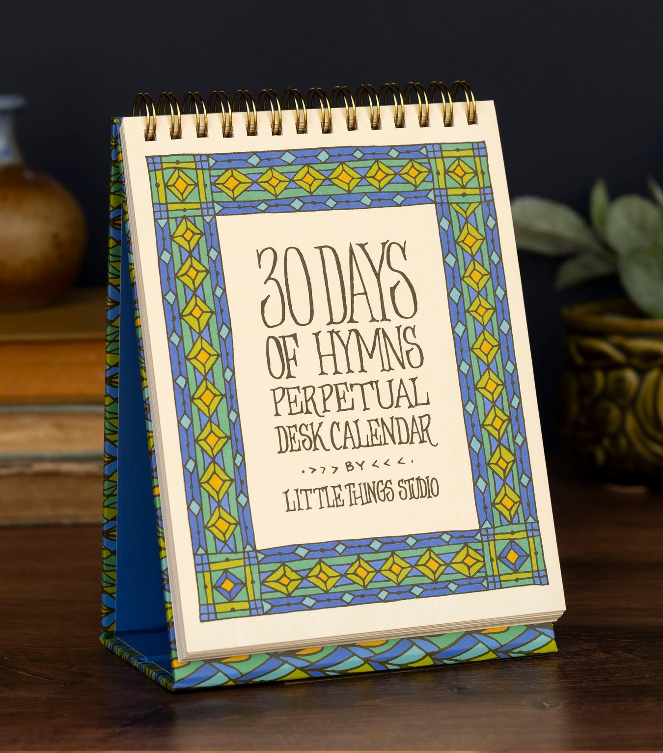 30 days of hymns perpetual calendar on an easel with intricate illustration