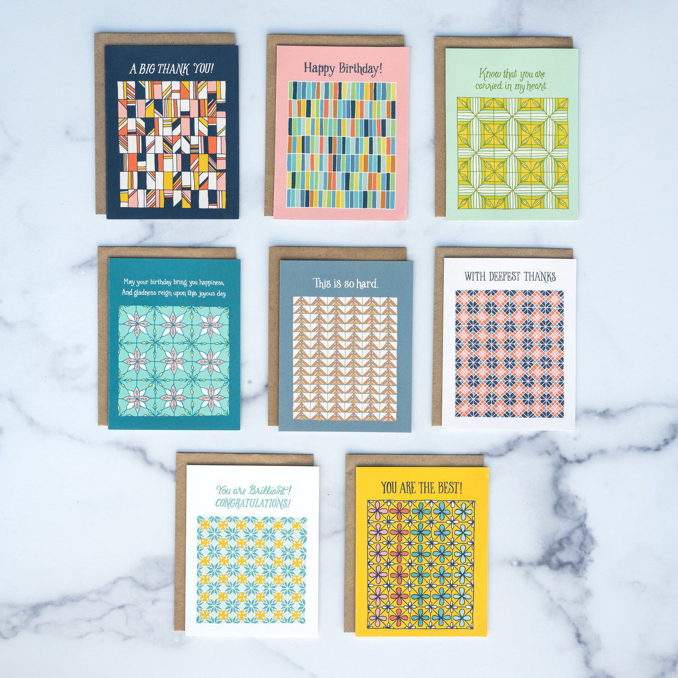 Everyday greeting cards by Little Things Studio are perfect to have on hand to send caring messages to loved ones. Each card features a colorful geometric design and a blank inside. Shown here against a marble backdrop.