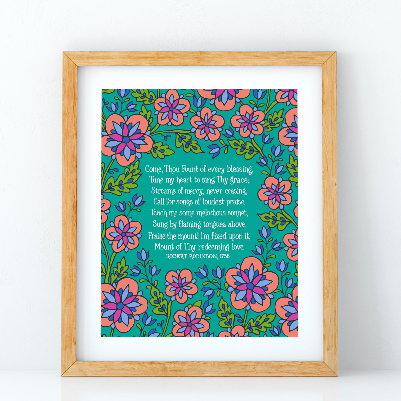 Great Is Thy Faithfulness hymn art print features the cherished hymn, surrounded by a bold blue and gold toned floral against a cream background; shown styled in a dark wood frame with a candle and a vase of flowers.