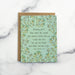 The Amazing Grace hymn greeting card, framed by dark mint and vintage yellow floral against a baby green background, shown with kraft paper envelope against a marble background.