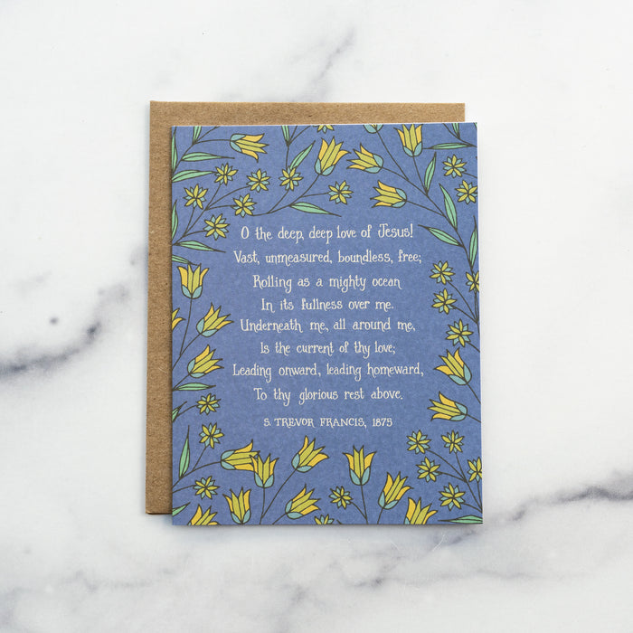 The O the Deep, Deep Love of Jesus hymn greeting card, framed by vintage yellow and dark mint floral against a deep water colored background, shown with a brown kraft paper envelope against a marble background.