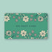 A Little Things Studio gift card in the amount of $50—a sage green card featuring custom LTS floral illustrations, shown against a light green background.