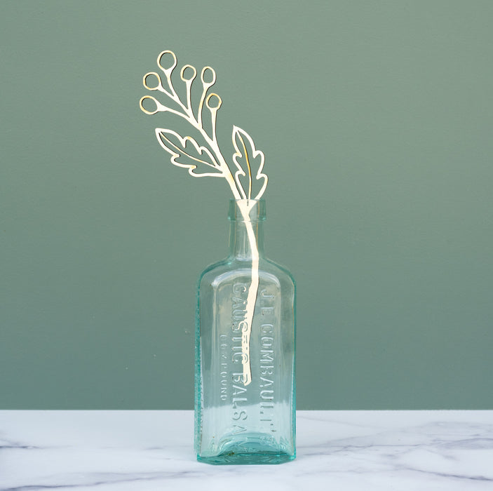 Enjoy flowers every day with Little Things Studio wooden floral stems. Each decorative stem features an intricate floral design cut from USA maple veneer. The Bitsy wooden floral stem design is shown here in a decorative glass vase on a marble tabletop.