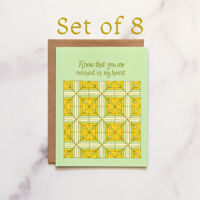 Always have a tender message ready with a set of 8 Carried in My Heart Greeting Cards. The hand illustrated patchwork pattern is highlighted in greens and yellows.