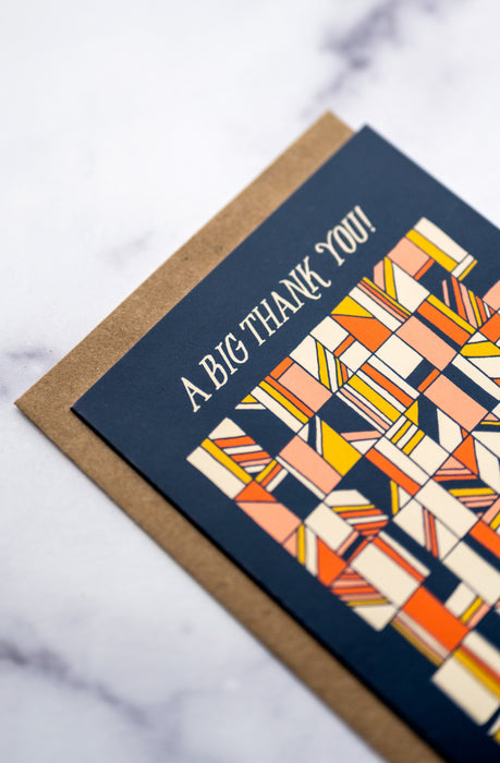 Design detail of a big thank you greeting card with a navy blue background and geometric pattern on the front