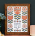 The "For God Gave Us" Scripture art print features the hand-lettered verse accented by peach and coral flowers with a buttermilk background, shown in a wooden frame and styled with a vase of dried flowers and a mug.