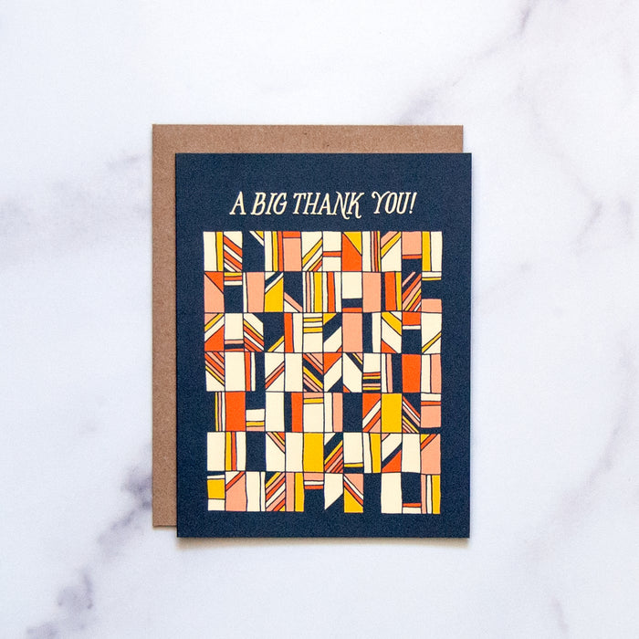 The Big Thank You greeting card by Little Things Studio features a retro geometrical design against a navy background with a blank inside, shown against a marble background.