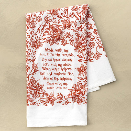 Abide with Me hymn tea towel printed in country red, pictured folded against a khaki background