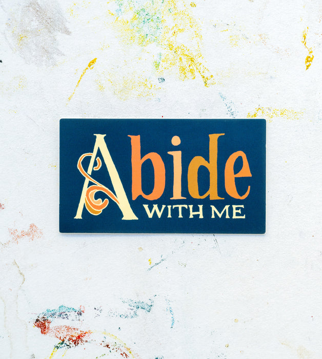 Introducing hymn stickers by Little Things Studio! The "Abide with Me" hymn sticker features multi-colored, hand lettered text with a botanical flourish, shown against a white worktable background.