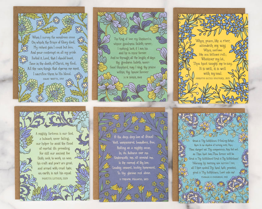 Each of the 6 hymn greeting cards in set "Baker" features a hymn's lyrics on the front and its history on the back, shown here flat with recycled kraft paper envelopes against a marble background.