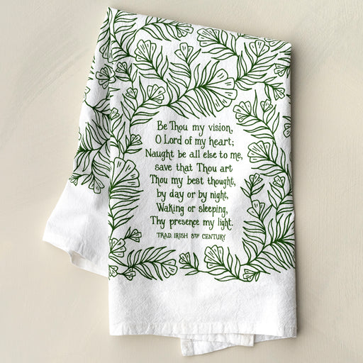 The Be Thou My Vision hymn tea towel is printed in forest green and features lyrics from the hymn, shown folded against a khaki backdrop.