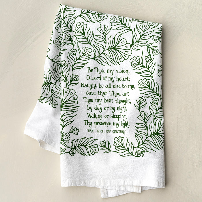 The Be Thou My Vision hymn tea towel is printed in forest green and features lyrics from the hymn, shown folded against a khaki backdrop.