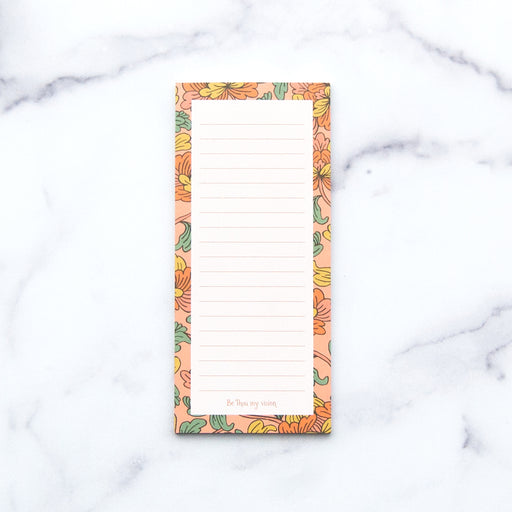 The "Be Thou My Vision" notepad features a hand illustrated floral border, "Be Thou my vision" at the bottom, and a magnet on back, shown against a white marble background.