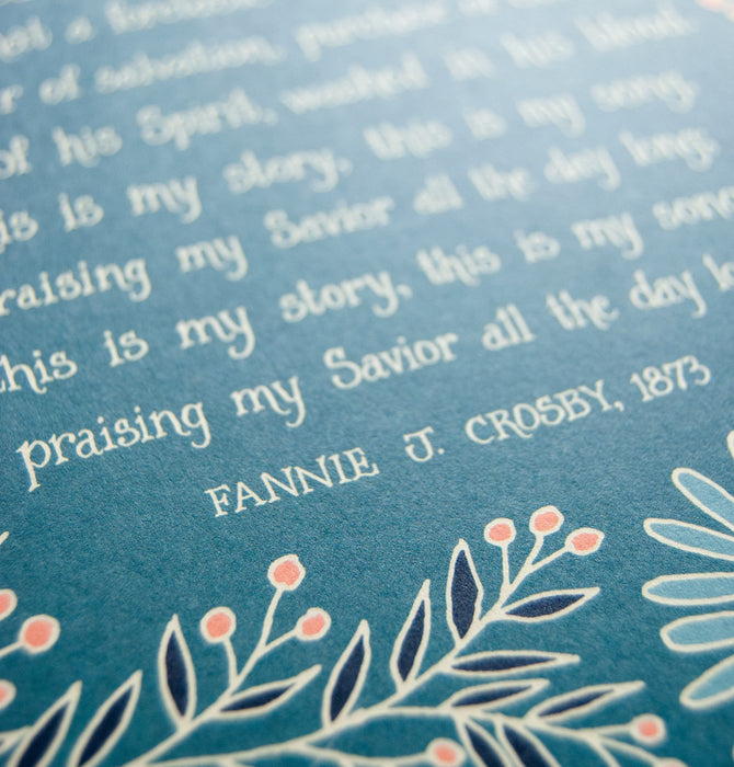 Hand lettered text detail of Blessed Assurance wall art — Christian home wall decor printed on a teal background surrounded by vibrant floral illustrations in blue, navy, cream and mandarin