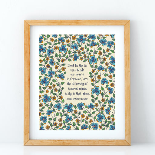 Blest be the Tie hymn art print, featuring hand lettered text offset by delicate hand illustrated floral designs, printed on a cream background, displayed in light wood frame against a white background.