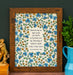 Blest be the Tie hymn art print, featuring hand lettered text offset by delicate hand illustrated floral designs, printed on a cream background, displayed in a dark wood frame with a pitcher of greens and ceramic figurine.