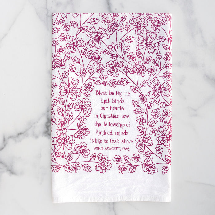 Blest Be the Tie hymn tea towel, printed on a cotton flour sack in midnight magenta, displayed against a white marble backdrop