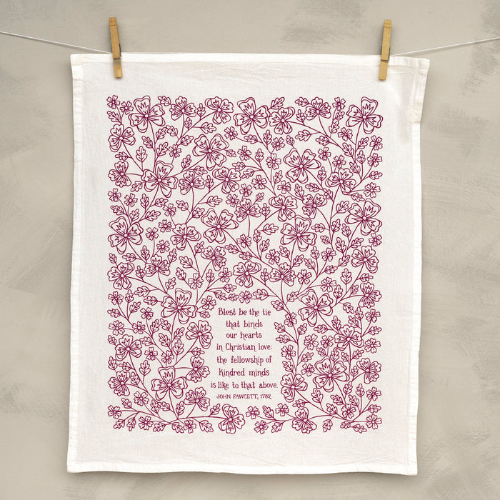 Blest Be the Tie hymn tea towel, printed on a cotton flour sack in midnight magenta, displayed unfolded and hung with clothes pins