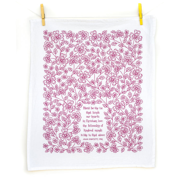 Blest Be the Tie hymn tea towel, printed on a cotton flour sack in midnight magenta, displayed unfolded and hung with clothes pins