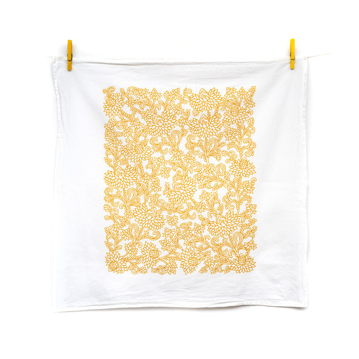 Little Things Studio presents floral tea towels featuring our unique illustrations in colorful hues. The Cordelia floral tea towel displays intricate florals in a cheerful daffodil, displayed unfolded and hanging with clothes pins.