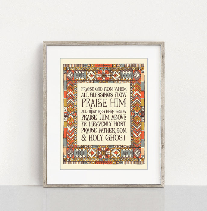 Doxology hymn art print — an 11x14 hand-lettered print showcasing a muted blue, red, and yellow stained glass border around dark text placed in a light colored frame