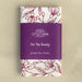 For the Beauty hymn tea towel is printed in pink plum and features delicate floral illustrations and hand-lettered lyrics from the hymn; shown folded and wrapped with a paper belly band for gift giving