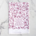 For the Beauty hymn tea towel is printed in pink plum and features delicate floral illustrations and hand-lettered lyrics from the hymn; shown folded against a white marble background.