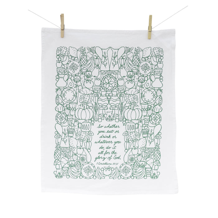 The For the Glory of God Scripture tea towel is printed in forest green and features 1 Corinthians 10:31, shown full length, hanging from clothes pins