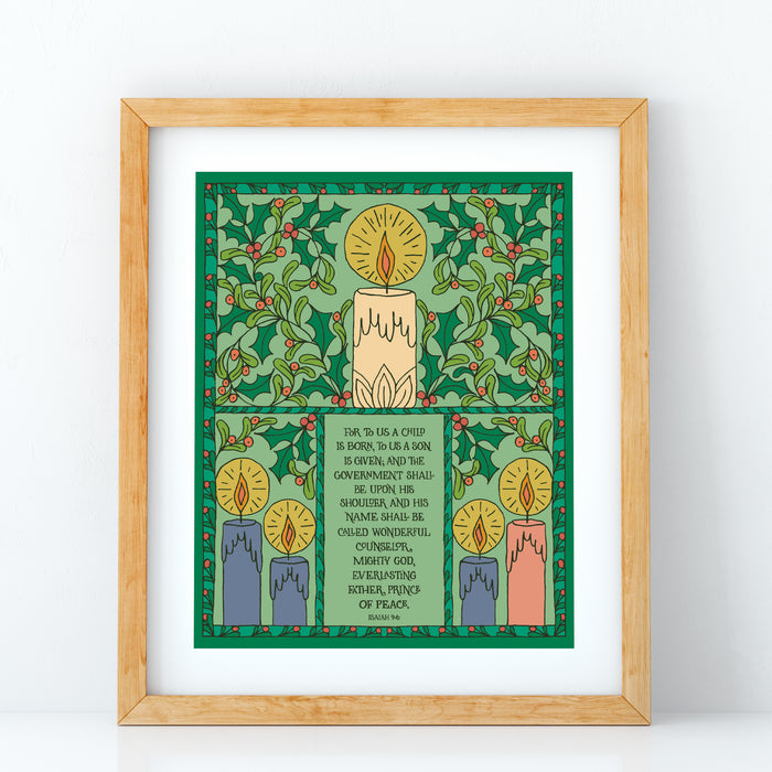 The For to Us a Child Is Born hymn art print features the beloved hymn text surrounded by illustrations of holly and advent candles against a wintergreen background; shown here in a wooden frame against a white background.