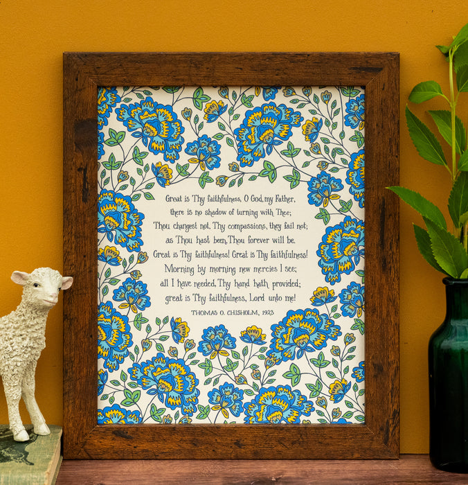 Be inspired daily with this exquisite "Great Is Thy Faithfulness" hymn art print from Little Things Studio — blue floral edition, shown styled in a frame with a vase of greens and a lamb figurine.