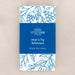 Great Is Thy Faithfulness tea towel is printed in a striking cerulean blue. The hand lettered text is surrounded by illustrated floral design, and the towel is shown folded and wrapped with a paper belly band.