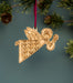 These flying musical angels in floral motif dresses are one of the 8 all-new Christmas hymn ornaments designed by Little Things Studio, pictured hung with ribbon from a Christmas tree.