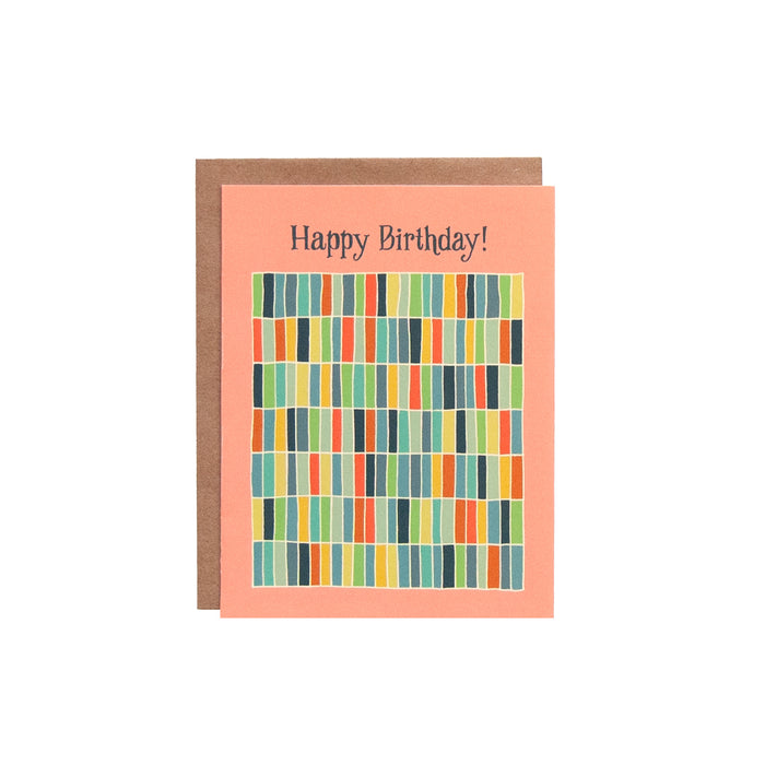 The Happy Birthday! Greeting Card features hand illustrated geometric design in a rainbow of hues against a happy peach background—a blank happy birthday card ready for your messages of affirmation.