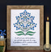 "He Will Cover You" Scripture art print features the hand-lettered verse from Psalm 91 accented by a beautiful blue and green floral against a fleecy white background. Shown here in a wooden frame, styled with a candle, books and a ceramic figure.