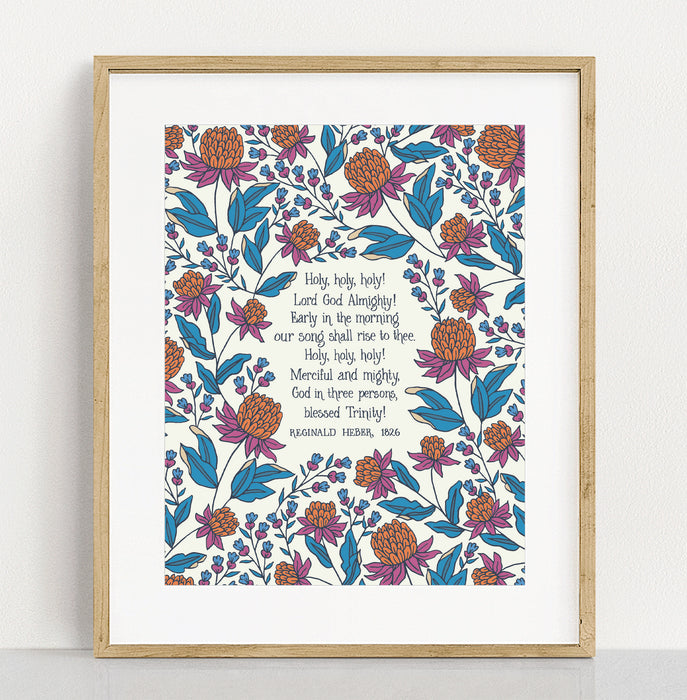 Holy Holy Holy art print — biblical wall art featuring hand lettered text surrounded by floral illustrations in shades of magenta, teal, and burnt orange displayed with matte in a frame against a white background