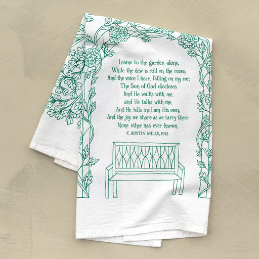 The much loved gospel song "In The Garden" is printed in a stunning paradise green on 100% cotton tea towel, shown here folded against a khaki backdrop.