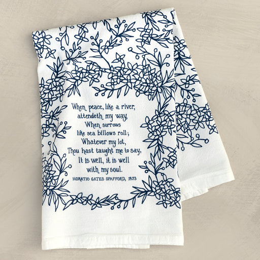 It Is Well With My Soul tea towel is printed in a striking cobalt blue and is shown folded and lying against a khaki background.