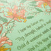 Hand lettered text detail of the Jesus Paid It All art print — a religious wall hanging featuring hand-lettered hymn text printed on a light green background surrounded by floral accents in pink, light red, white, orange and green