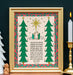 The "Good News of Great Joy" art print, which features the hand-lettered text of Luke 2:10–11 surrounded by festive trees and the wondering shepherds, is shown in a gold frame and styled with a candle and white ceramic tree and angel carving.