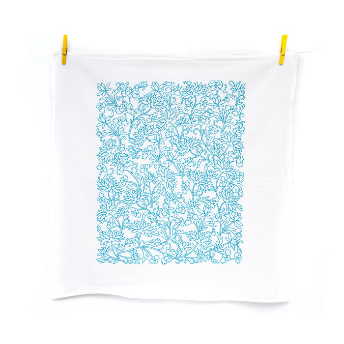 Little Things Studio presents floral tea towels — the Mabel floral tea towel features lively floral illustrations in vibrant turquoise, shown up unfolded and hanging with clothes pins