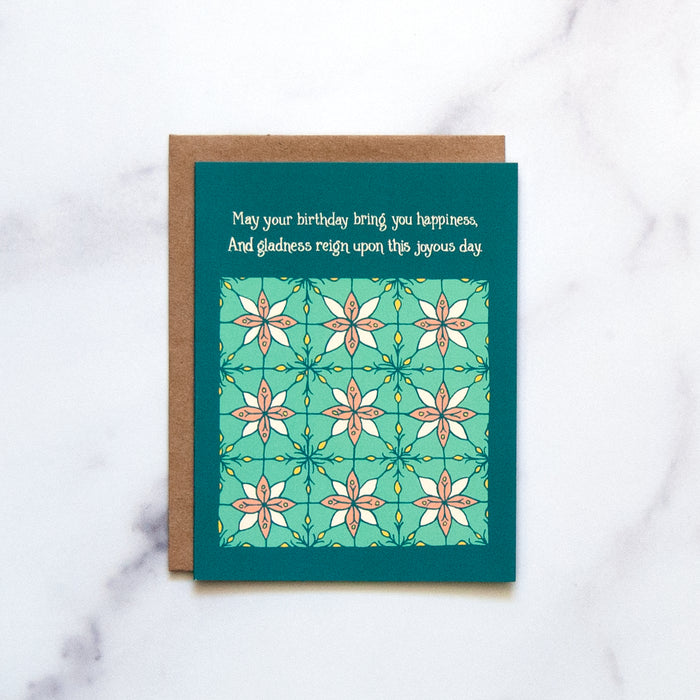 The Birthday Happiness Greeting Card features hand illustrated floral patterns in blue-greens and a splash of pink—a blank birthday card ready for your message