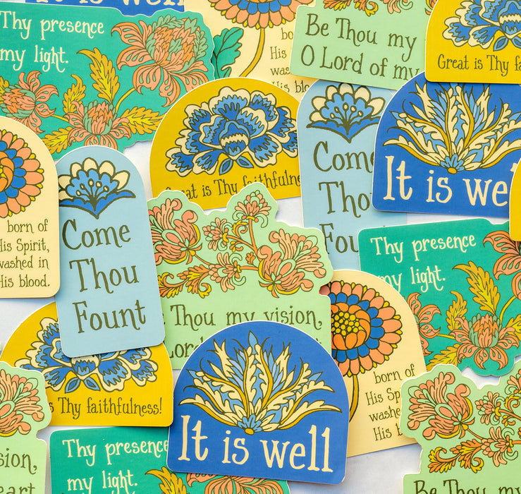 Stickers from Little Things Studio feature bold colors, unique floral and geometric designs, and encouraging hymn texts or quotes. Shown here spread out and overlapping one another.