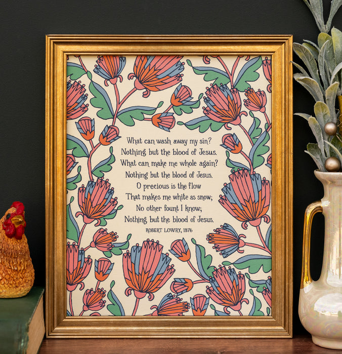 The "My Hope Is Built" hymn art print features the text surrounded by multi-colored florals against an aquamarine background; shown framed and styled with a vase of greens and a figurine.