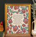 The "My Hope Is Built" hymn art print features the text surrounded by multi-colored florals against an aquamarine background; shown framed and styled with a vase of greens and a figurine.