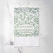 The "O Holy Night" hymn tea towel is hand-lettered with a festive holly border and angel heralds — two sided for use during both Advent and Christmas — and printed in rosemary green on a 100% cotton tea towel. Made in the USA, and shown here folded against a marble background.