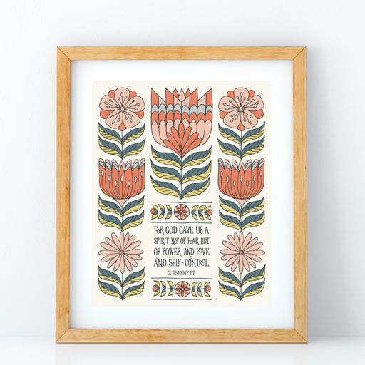 The "For God Gave Us" Scripture art print features the hand-lettered verse accented by peach and coral flowers with a buttermilk background, shown in a light wood frame against a white background.