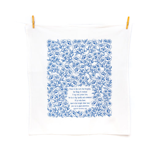 Praise to the Lord the Almighty hymn tea towel is printed in cobalt, displayed at full size, clipped with clothes pins