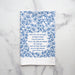 Praise to the Lord the Almighty hymn tea towel is printed in cobalt, displayed folded against a marble background.