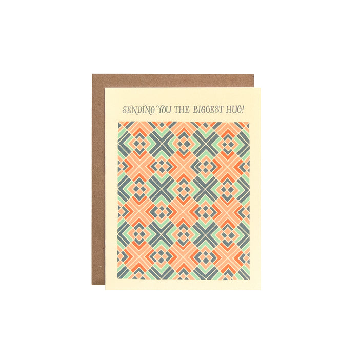 The Biggest Hug Greeting Card features a hand illustrated geometric pattern in blues and corals, pictured against a white background.