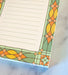 Detail of mini stained glass notepad featuring vibrant border illustration and lined for all your list making or note jotting needs.